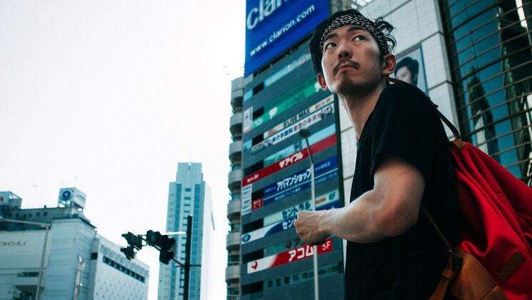 Man studying Japanese studies walking in Tokyo. Photo: Unsplash